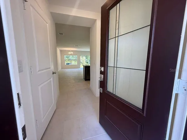 a view of a hallway with a refrigerator