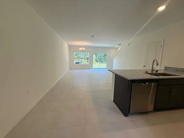 a kitchen with a sink cabinets and a window
