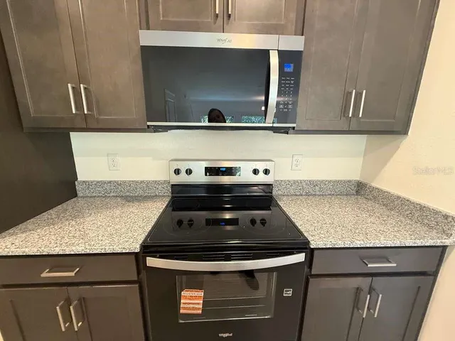 a stove top oven sitting inside of a kitchen