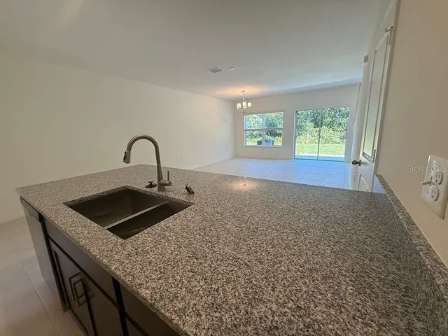 a kitchen with granite countertop a sink and a window