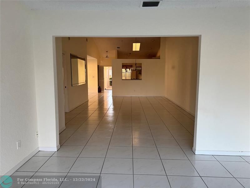 3727 Southwest Whispering Sound Drive Palm City, FL 34990 - Photo 14 of 29 a view of a hallway to a room with wooden floor and cabinet