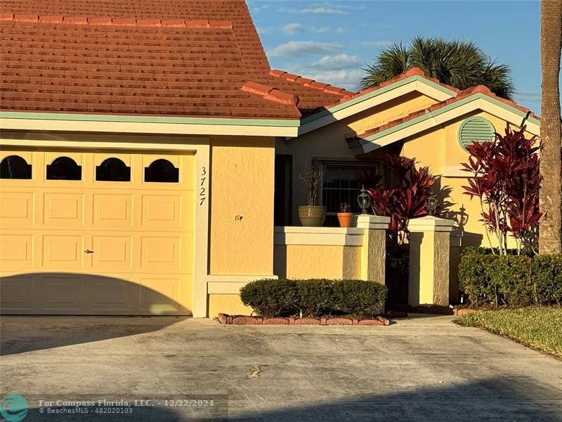 3727 Southwest Whispering Sound Drive Palm City, FL 34990 - Photo 2 of 29 front view of a house with a garage