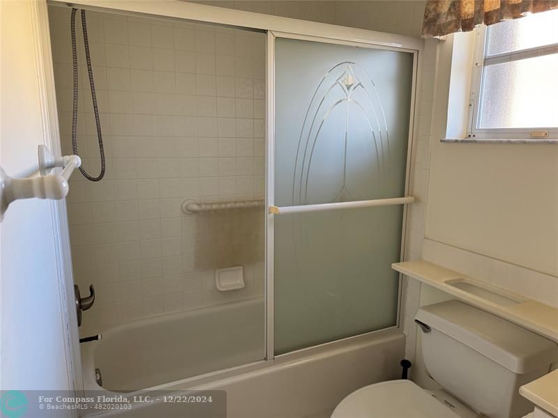 3727 Southwest Whispering Sound Drive Palm City, FL 34990 - Photo 6 of 29 a bathroom with a shower and a toilet