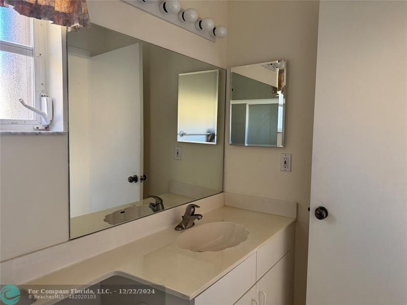 3727 Southwest Whispering Sound Drive Palm City, FL 34990 - Photo 7 of 29 a bathroom with a sink and a mirror