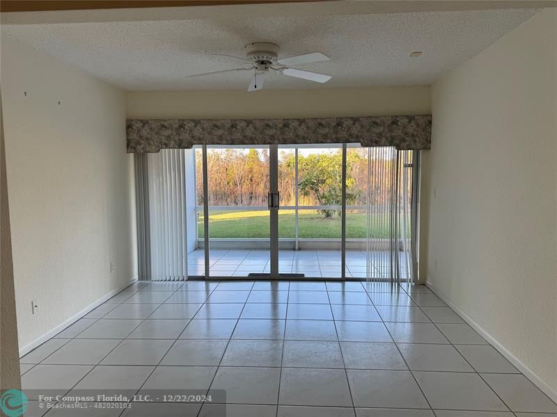3727 Southwest Whispering Sound Drive Palm City, FL 34990 - Photo 8 of 29 a view of a livingroom with a floor to ceiling window and an entryway