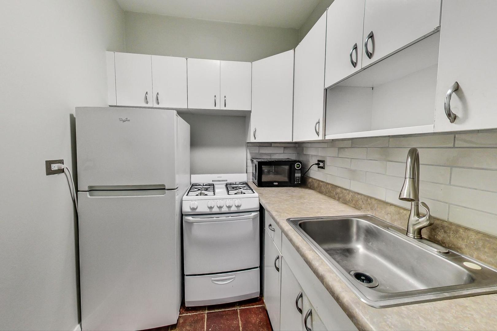 6101 North Sheridan Road, Unit 6H Chicago, IL 60660 - Photo 13 of 29 a white refrigerator freezer sitting inside of a kitchen