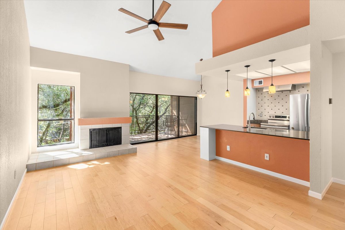 4711 Spicewood Springs Road, Unit 4222 Austin, TX 78759 - Photo 1 of 35 Natural light floods this inviting living room with high, vaulted ceilings and a view of the outdoors.