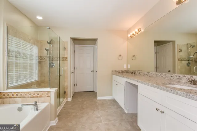 a spacious bathroom with a sink mirror and a bathtub