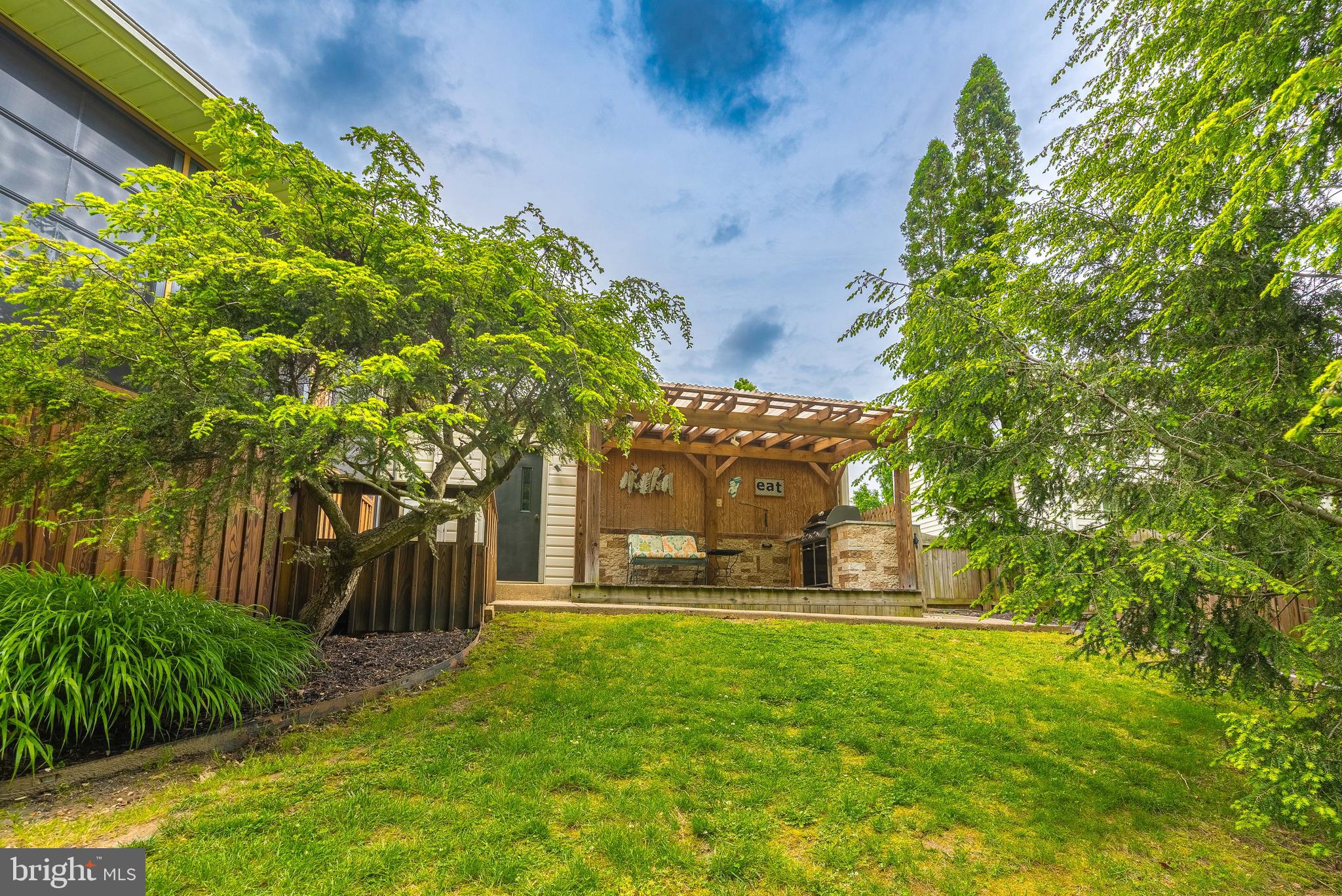9679 Baltimore Avenue Laurel, MD 20723 - Photo 12 of 56 a view of a yard with plants and large trees