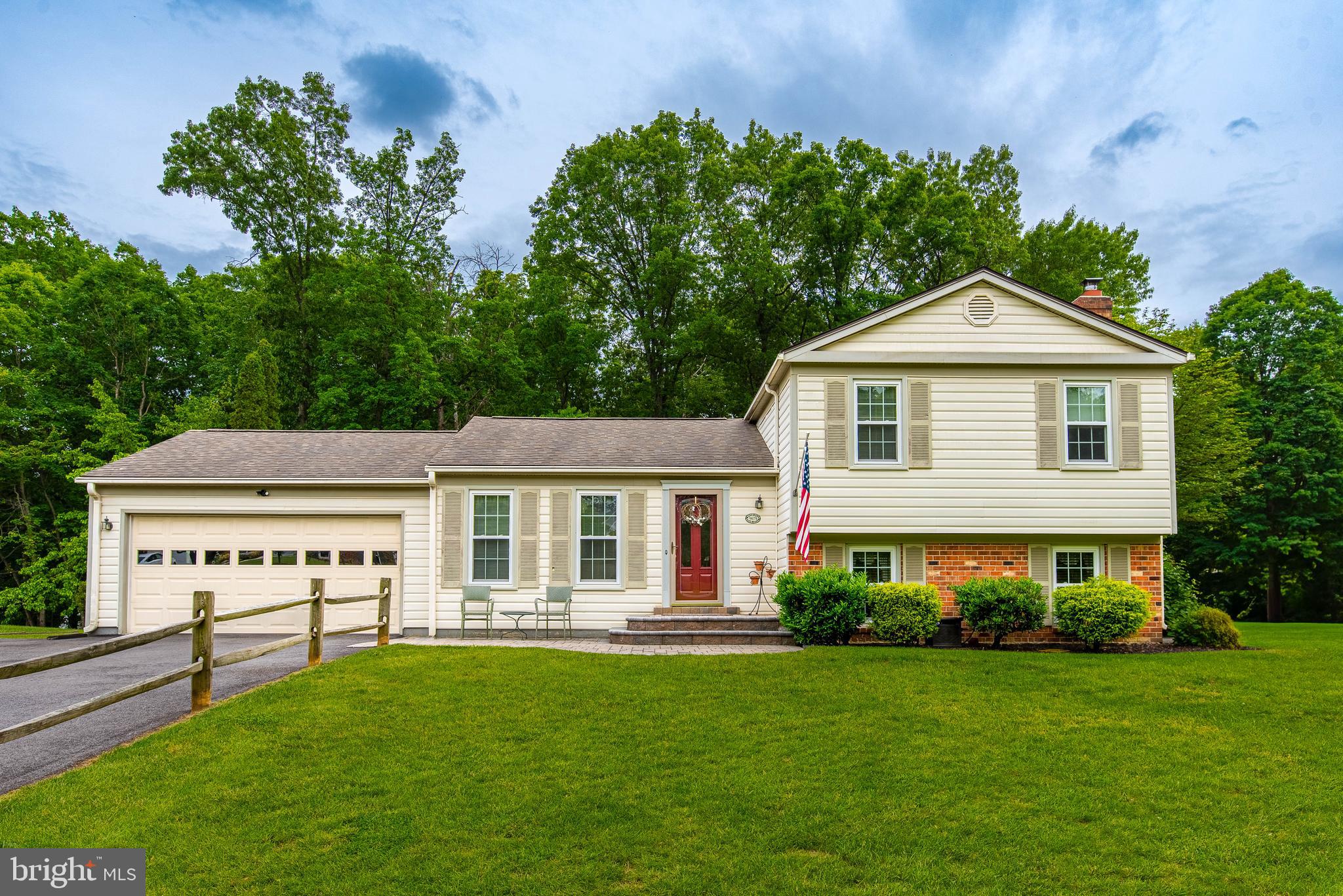 9679 Baltimore Avenue Laurel, MD 20723 - Photo 2 of 56 a front view of a house with a garden