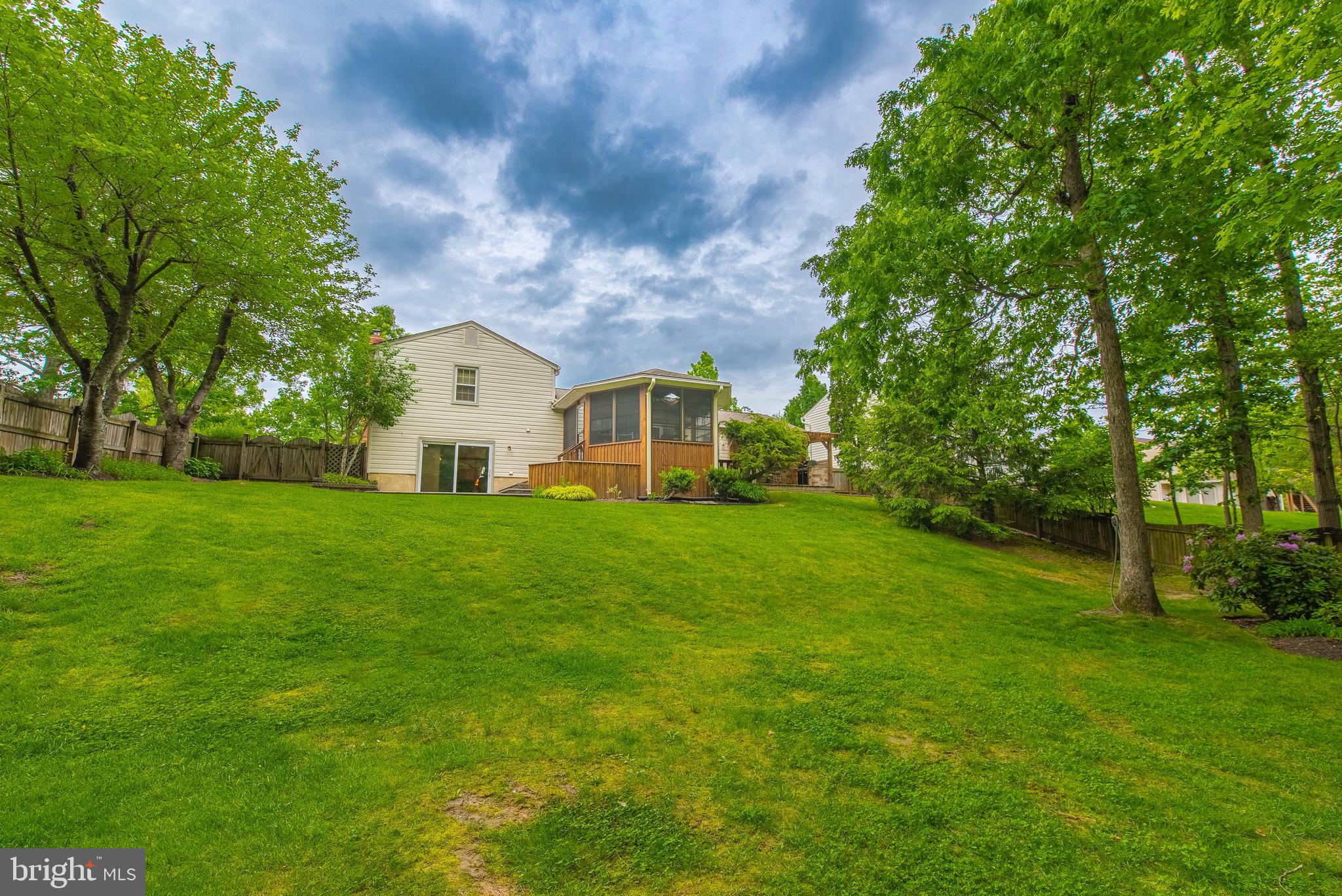 9679 Baltimore Avenue Laurel, MD 20723 - Photo 24 of 56 a view of a white house in front of a big yard with large trees