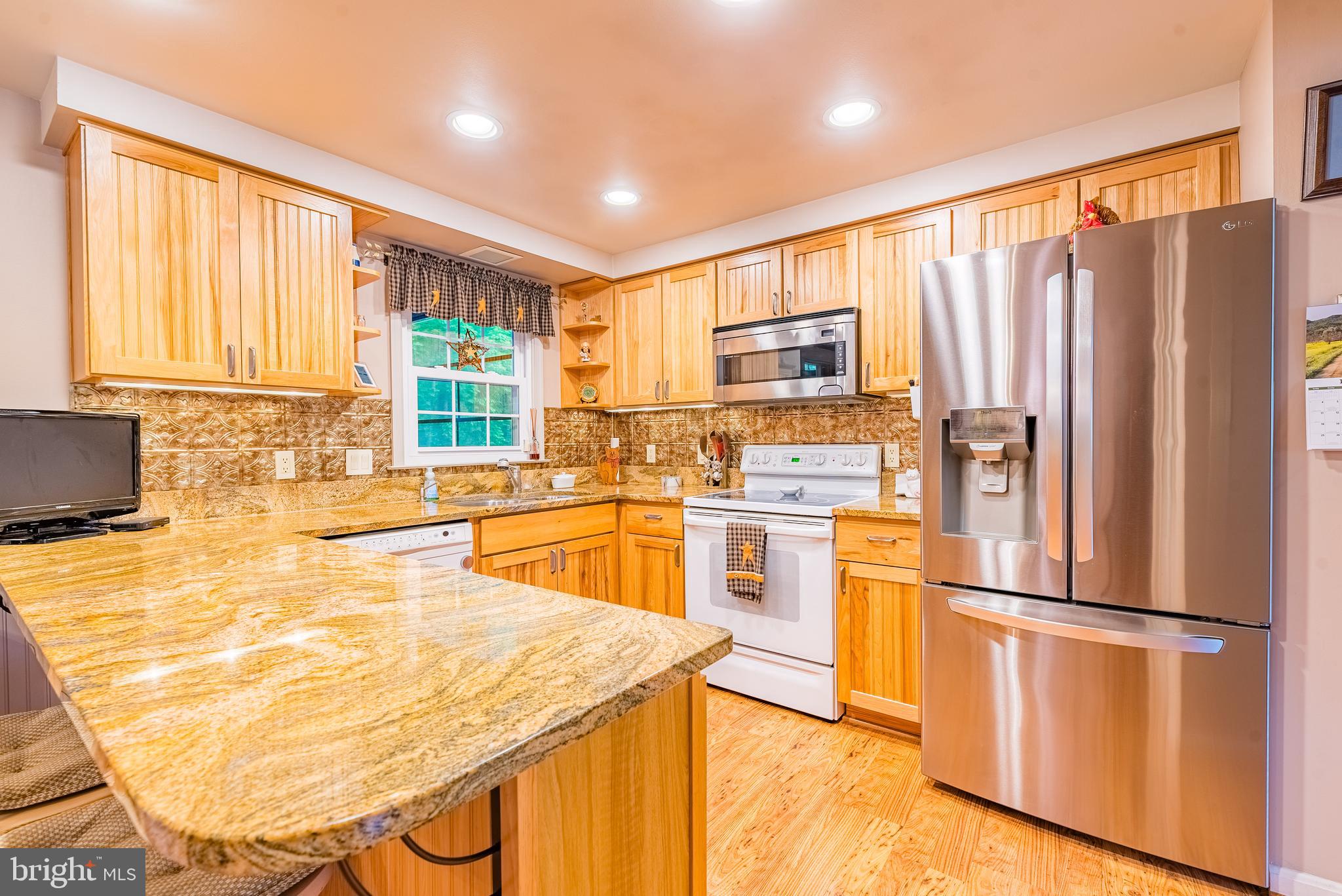 9679 Baltimore Avenue Laurel, MD 20723 - Photo 30 of 56 a kitchen with stainless steel appliances wooden floor and window