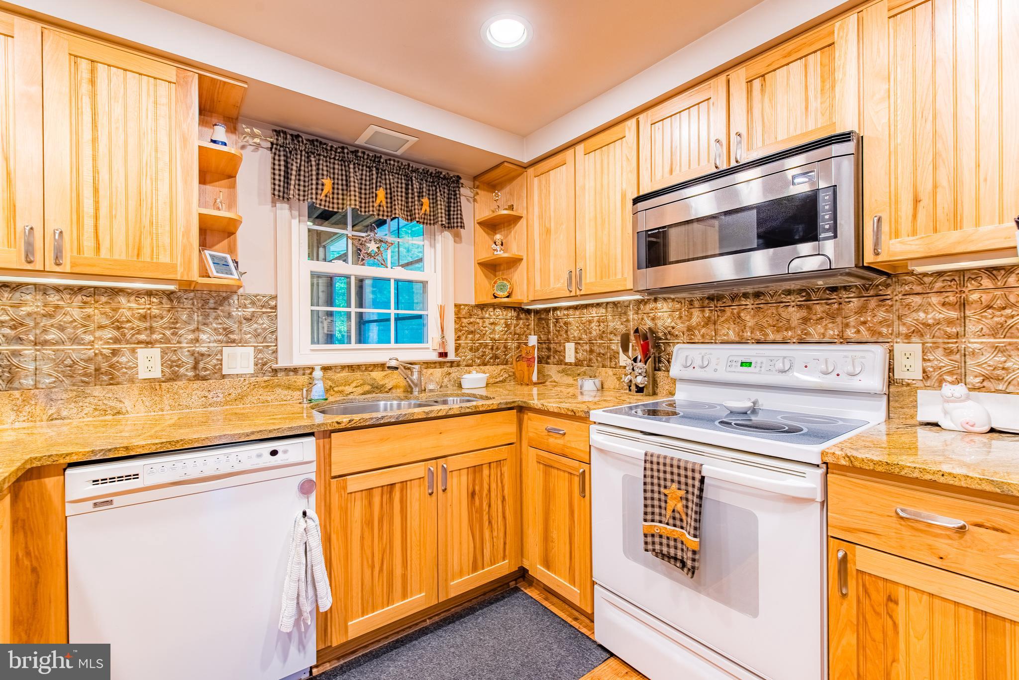 9679 Baltimore Avenue Laurel, MD 20723 - Photo 32 of 56 a kitchen with a stove a sink and a microwave