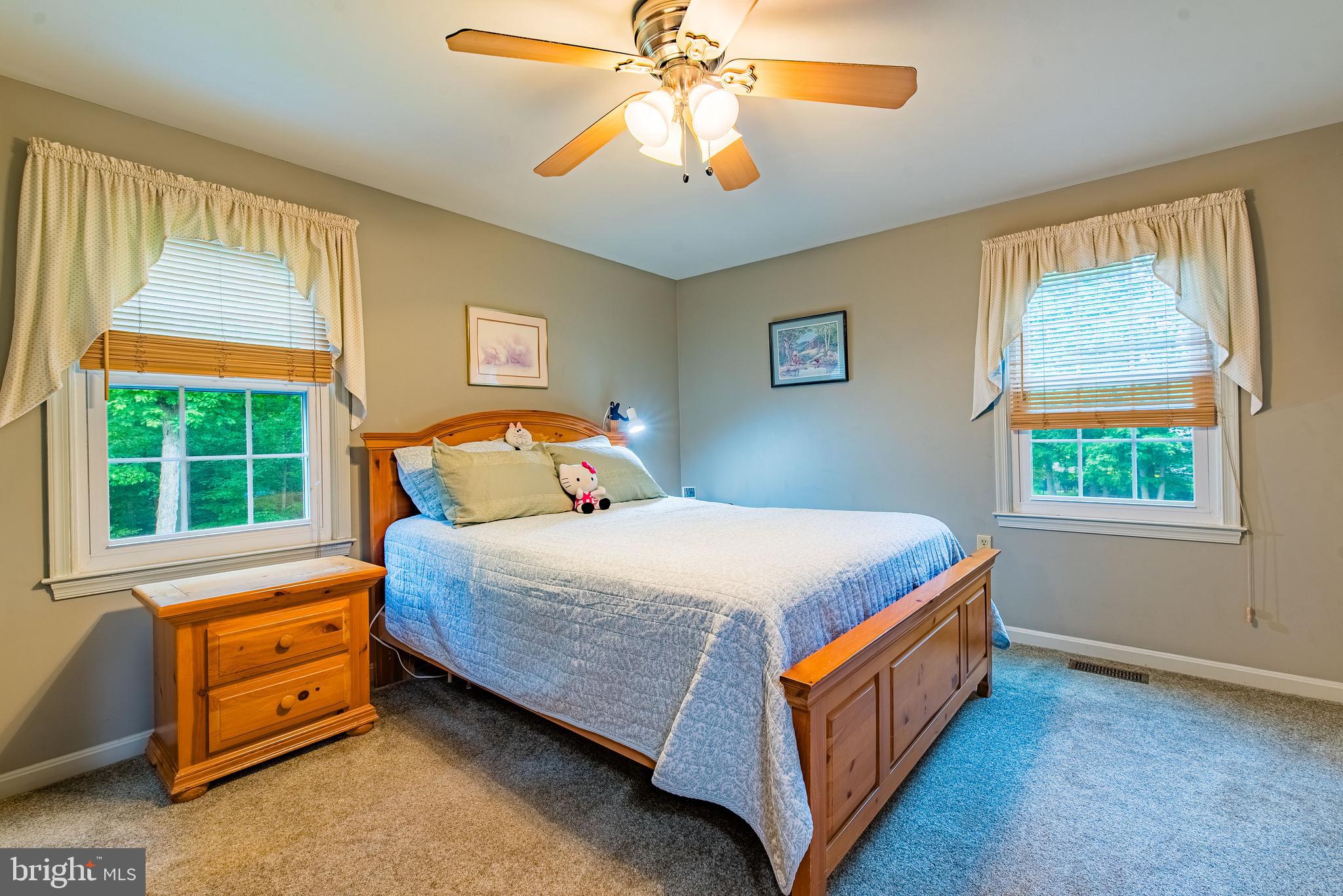 9679 Baltimore Avenue Laurel, MD 20723 - Photo 36 of 56 a bed sitting in a bedroom next to a window