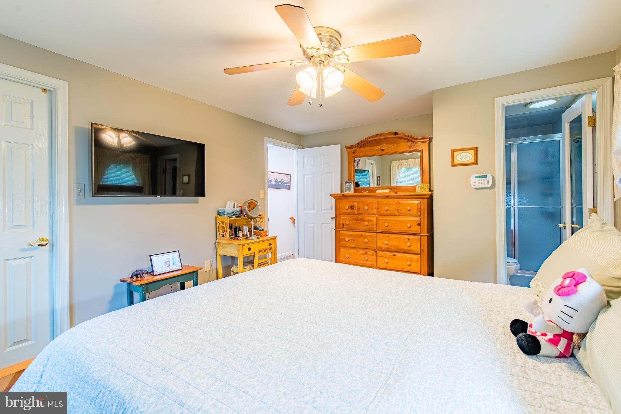 9679 Baltimore Avenue Laurel, MD 20723 - Photo 37 of 56 a bedroom with a bed and a flat tv screen on dresser