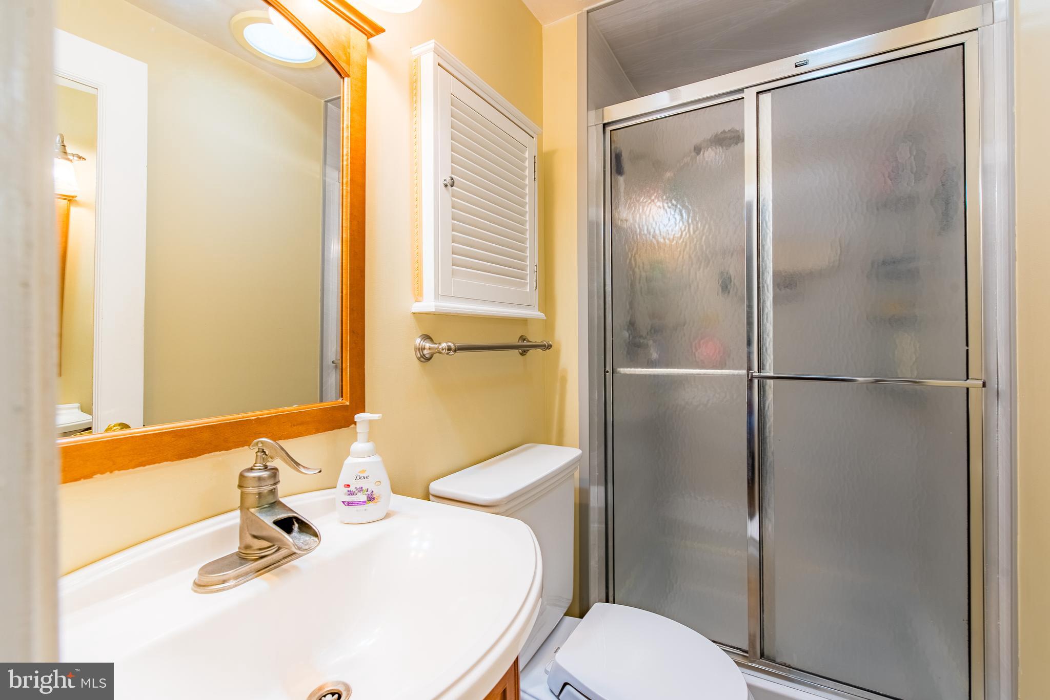 9679 Baltimore Avenue Laurel, MD 20723 - Photo 38 of 56 a bathroom with a sink toilet and shower