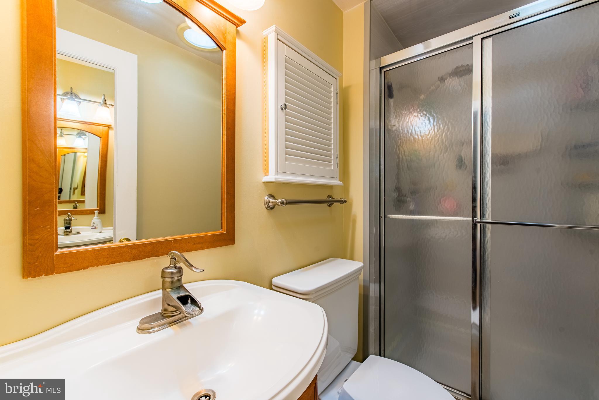 9679 Baltimore Avenue Laurel, MD 20723 - Photo 39 of 56 a bathroom with a sink toilet and shower