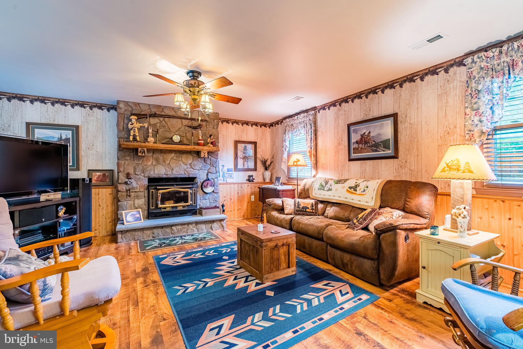 9679 Baltimore Avenue Laurel, MD 20723 - Photo 44 of 56 a living room with furniture a flat screen tv and a fireplace