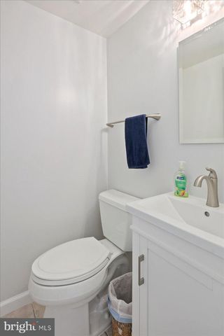 a view of a workspace with bookshelf and a window