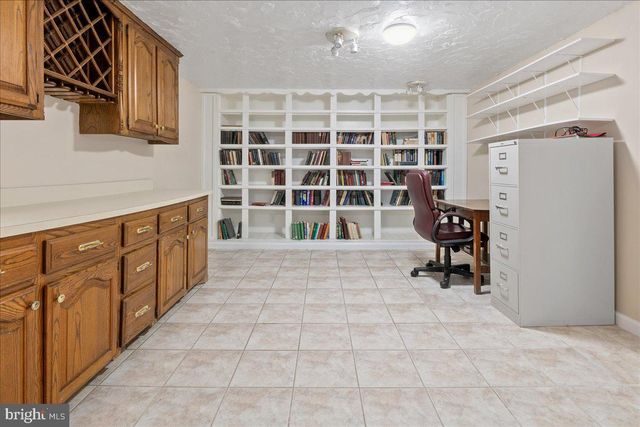a backyard of a house with a fountain and outdoor seating
