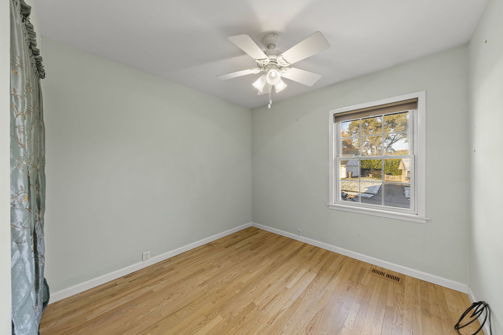 710 Cascade Avenue Romeoville, IL 60446 - Photo 8 of 25 a view of an empty room with wooden floor and a window