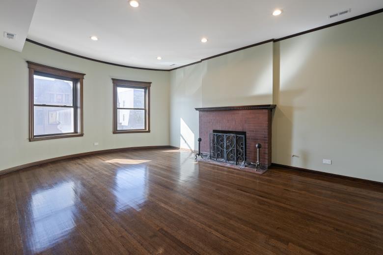 446 East 48th Street, Unit 3E Chicago, IL 60615 - Photo 13 of 33 an empty room with wooden floor fireplace and windows