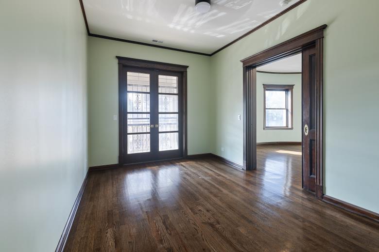 446 East 48th Street, Unit 3E Chicago, IL 60615 - Photo 15 of 33 an empty room with wooden floor and windows