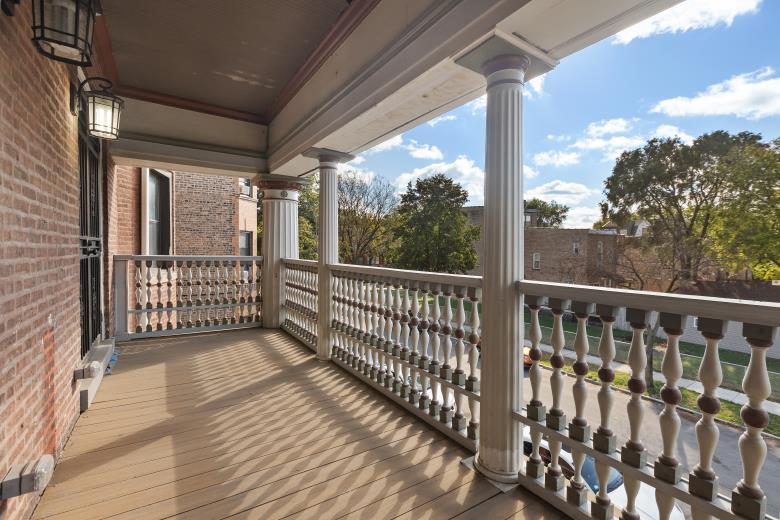 446 East 48th Street, Unit 3E Chicago, IL 60615 - Photo 16 of 33 a view of a balcony with wooden floor