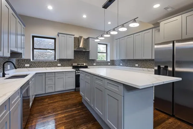 a kitchen with granite countertop a stove sink and cabinets