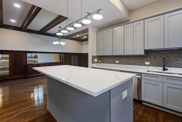 a bathroom with a granite countertop sink a light fixture and a mirror