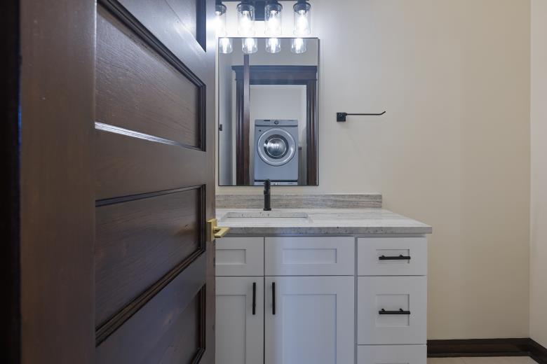 446 East 48th Street, Unit 3E Chicago, IL 60615 - Photo 23 of 33 a bathroom with a granite countertop sink a light fixture and a mirror