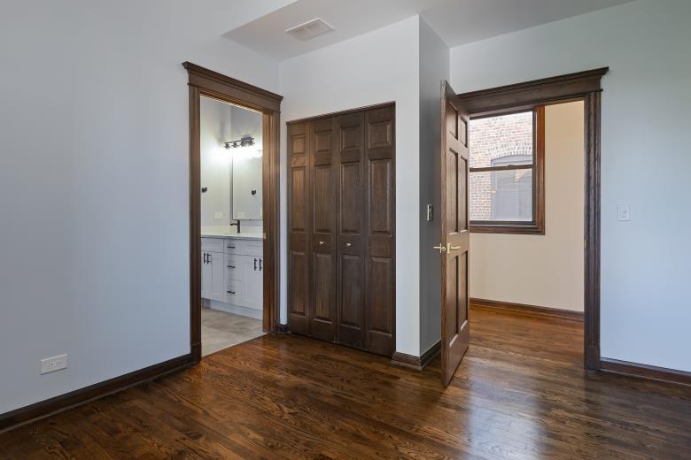 446 East 48th Street, Unit 3E Chicago, IL 60615 - Photo 28 of 33 an empty room with wooden floor and windows