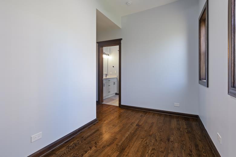 446 East 48th Street, Unit 3E Chicago, IL 60615 - Photo 32 of 33 a view of an empty room with wooden floor and closet