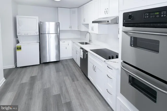 a kitchen with white cabinets and white appliances