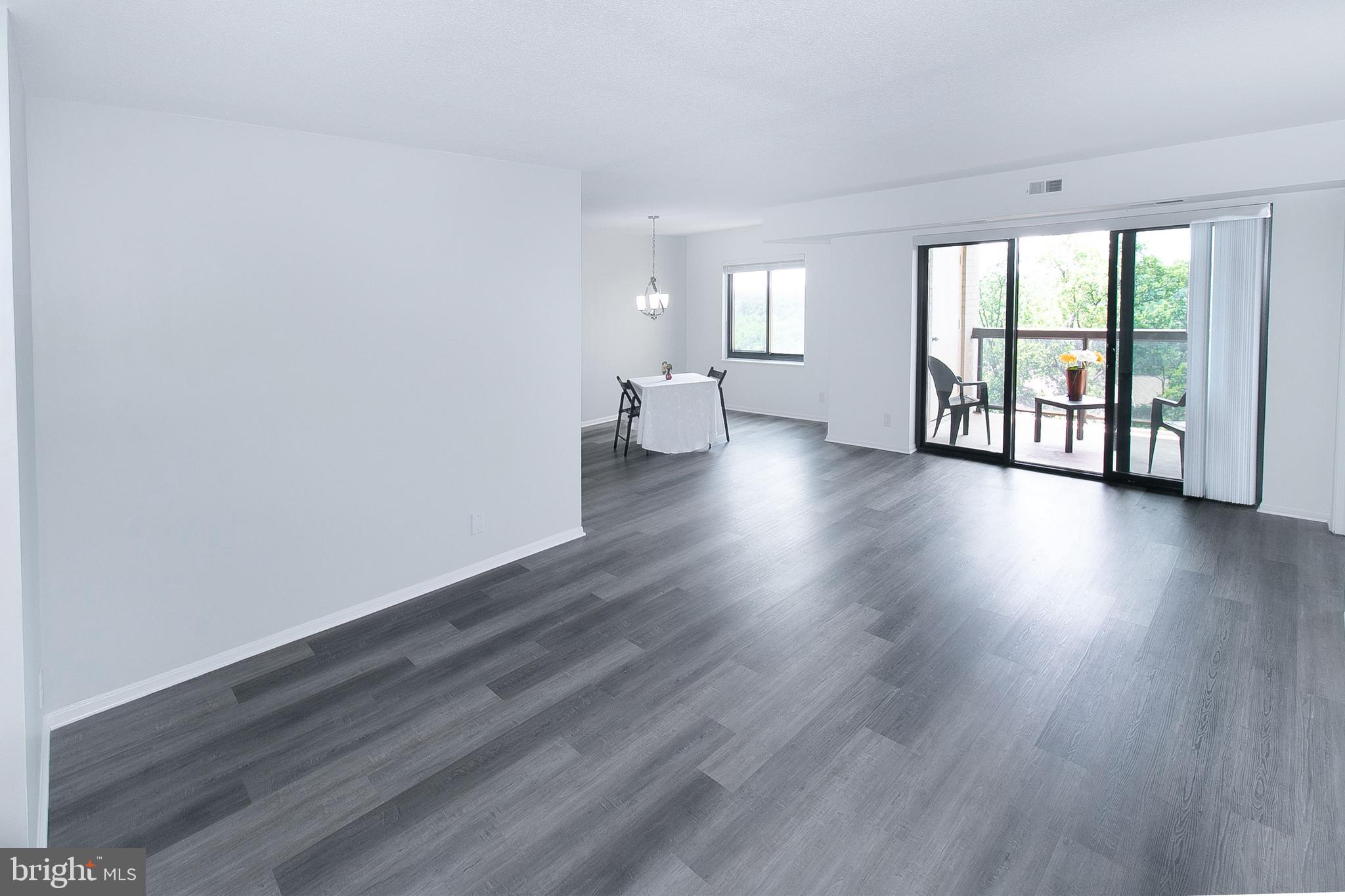307 Yoakum Parkway, Unit 1024 Alexandria, VA 22304 - Photo 15 of 50 a view of an empty room with wooden floor and a window