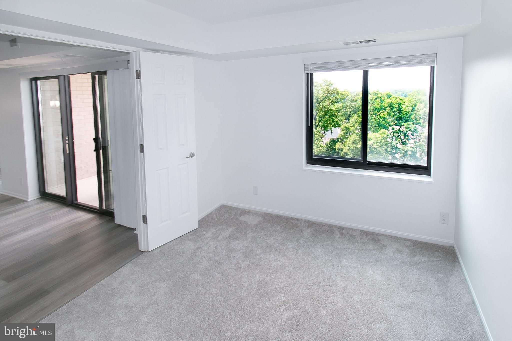 307 Yoakum Parkway, Unit 1024 Alexandria, VA 22304 - Photo 20 of 50 an empty room with windows