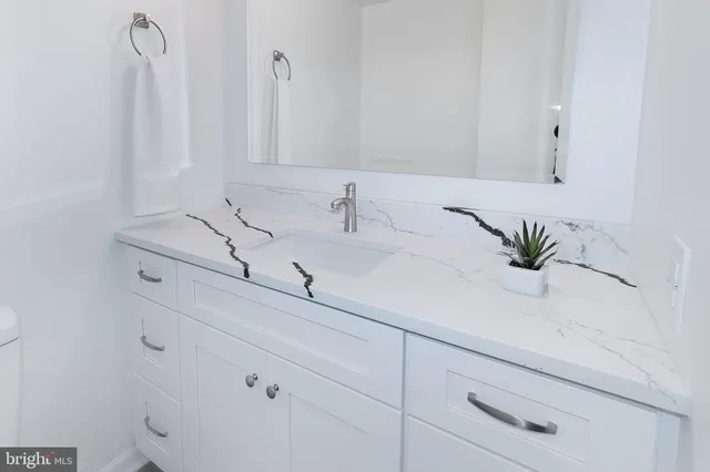 a bedroom with a bed potted plant and a window