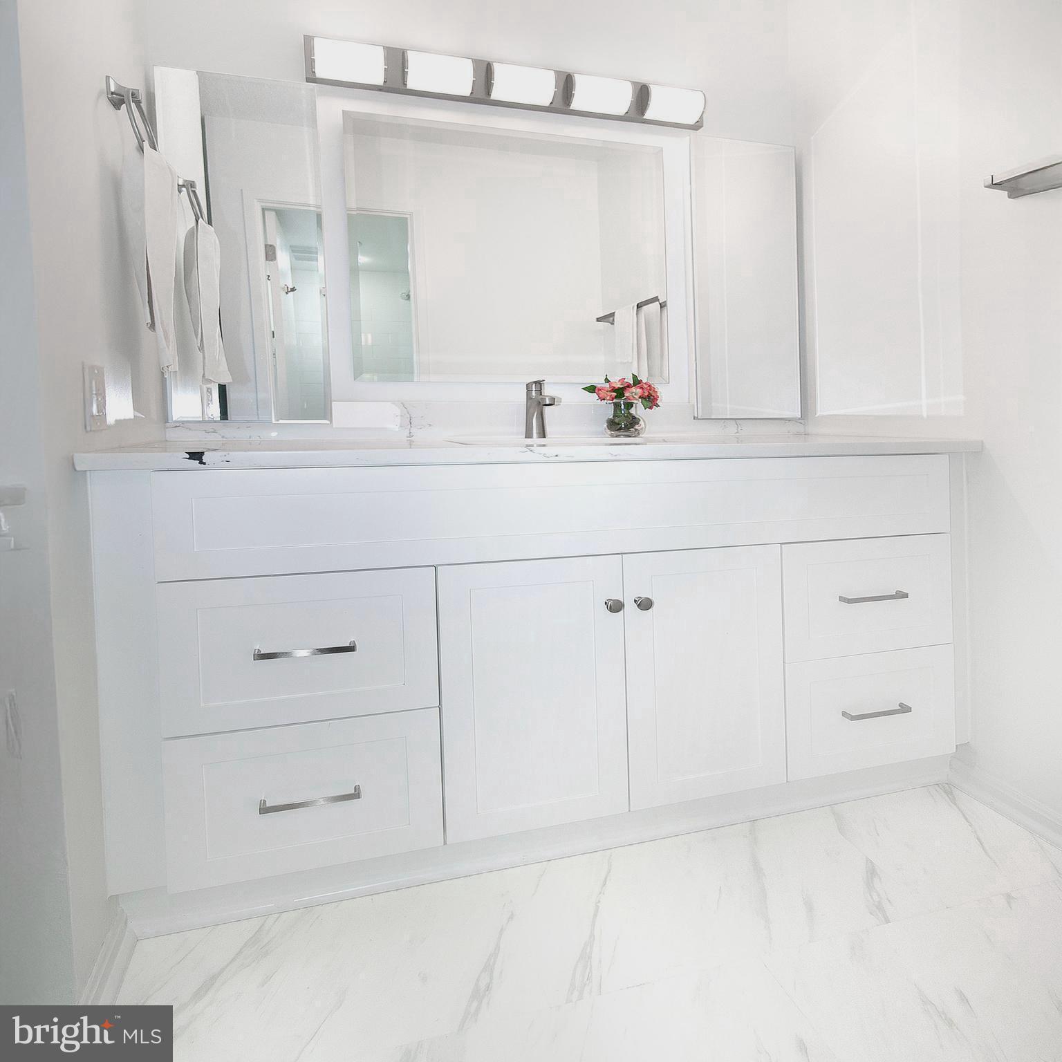 307 Yoakum Parkway, Unit 1024 Alexandria, VA 22304 - Photo 32 of 50 a bathroom with white cabinets and a sink