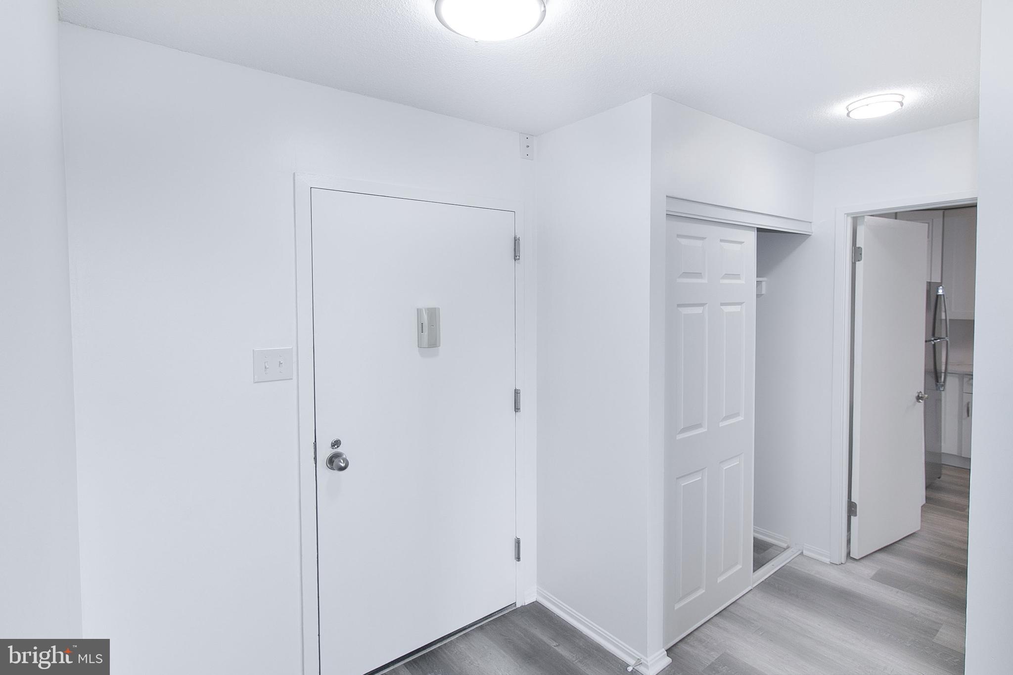 307 Yoakum Parkway, Unit 1024 Alexandria, VA 22304 - Photo 5 of 50 a view of a hallway with wooden floor