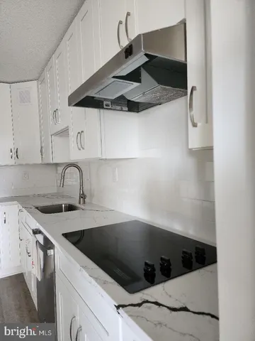 a kitchen with a sink cabinets and stainless steel appliances