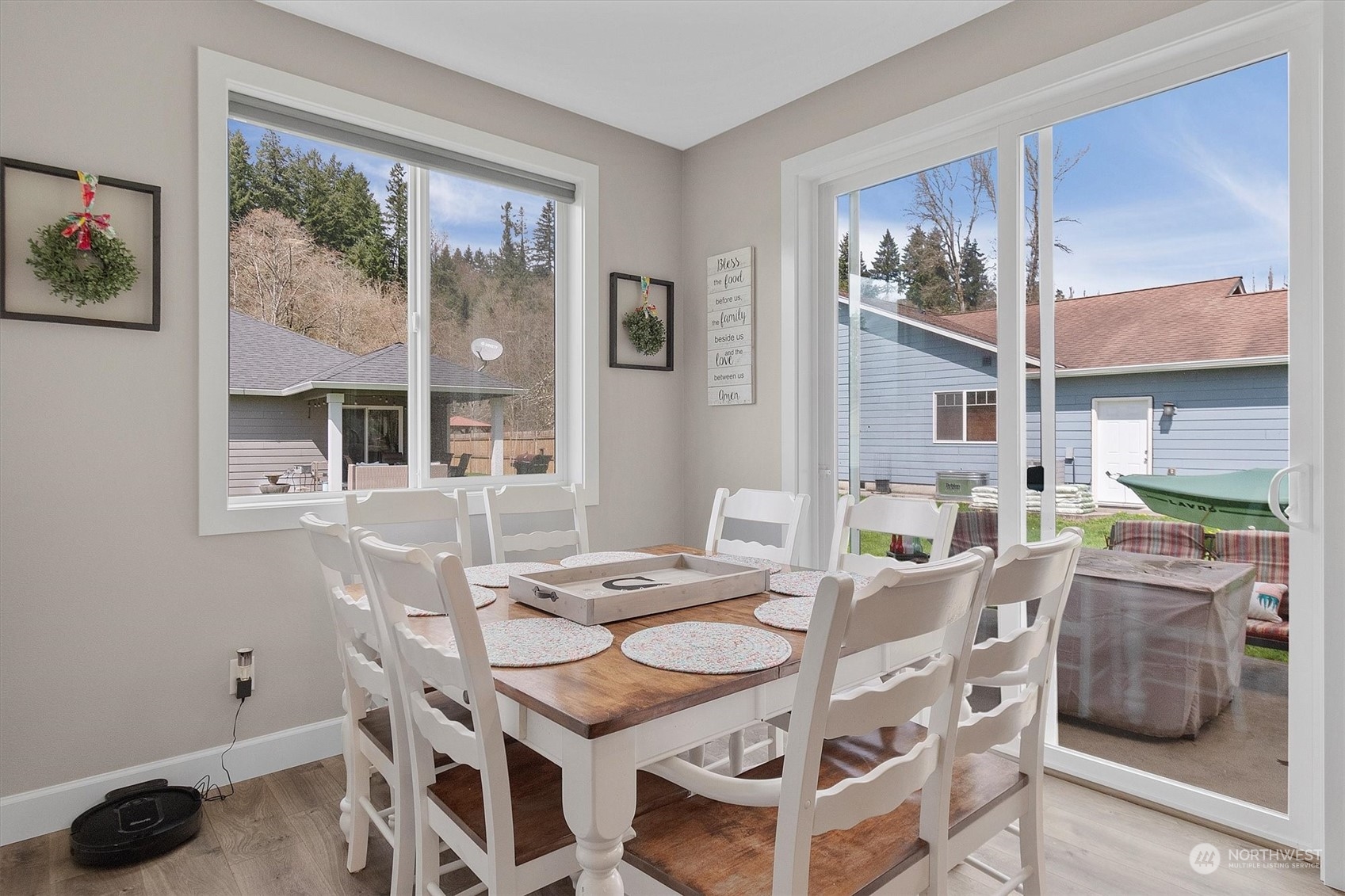 4768 Pacific Way Longview, WA 98632 - Photo 15 of 25 a view of a dining room with furniture large windows and wooden floor