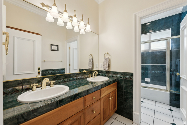 1714 Ridge Point Drive Bountiful, UT 84010 - Photo 89 of 132 Double vanity with wood cabinetry, tile countertop, and undermount sinks