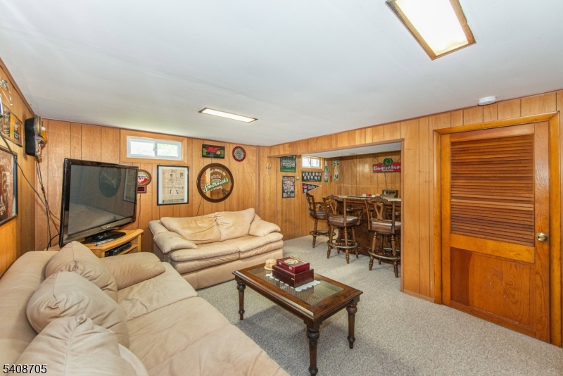 4 George Street Succasunna, NJ 07876 - Photo 14 of 34 a living room with furniture and a flat screen tv