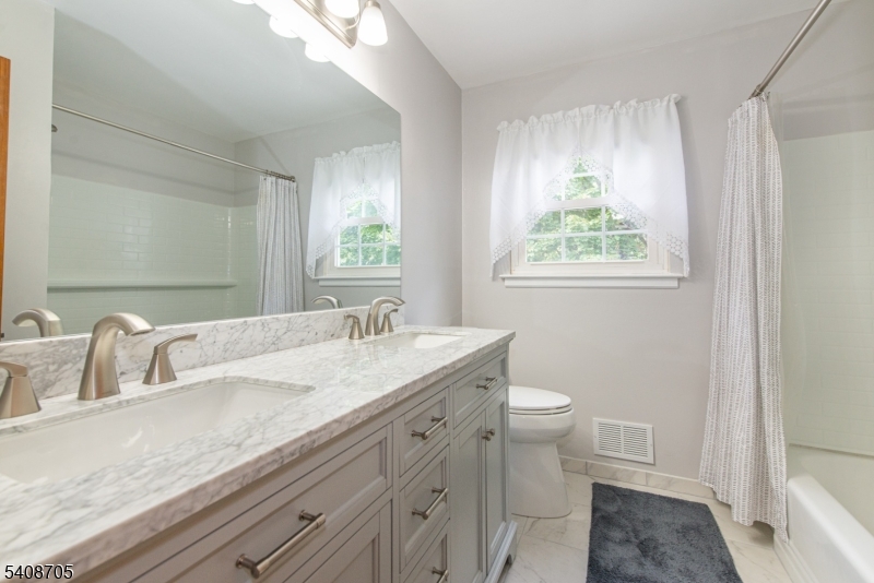 4 George Street Succasunna, NJ 07876 - Photo 24 of 34 a bathroom with a granite countertop sink a toilet and a mirror