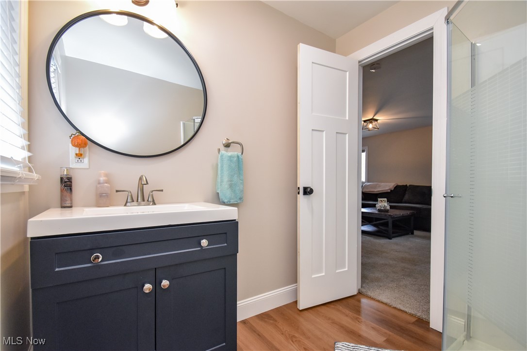 631 Carson Salt Springs Road Warren, OH 44481 - Photo 22 of 39 Bathroom with vanity, hardwood / wood-style flooring, and a shower with door