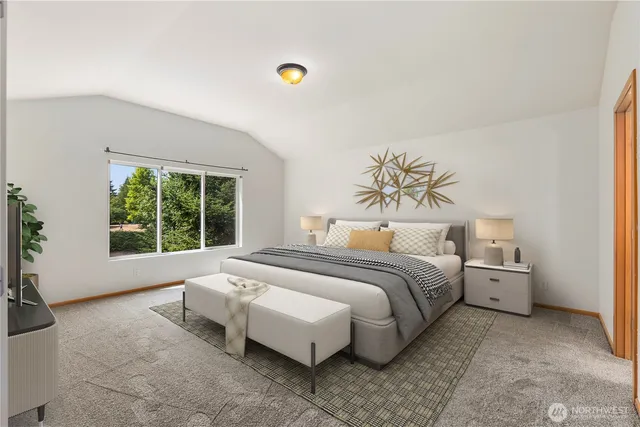 a spacious bedroom with a bed and window