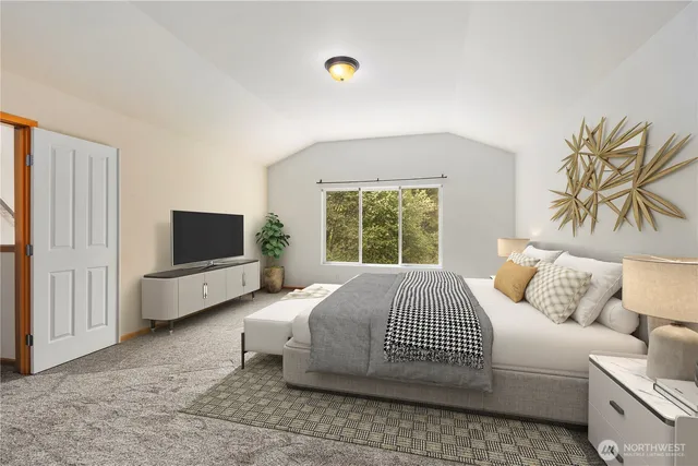 a bedroom with a bed and a television