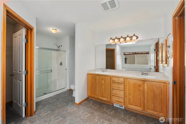 a spacious bathroom with a mirror sink and bathtub