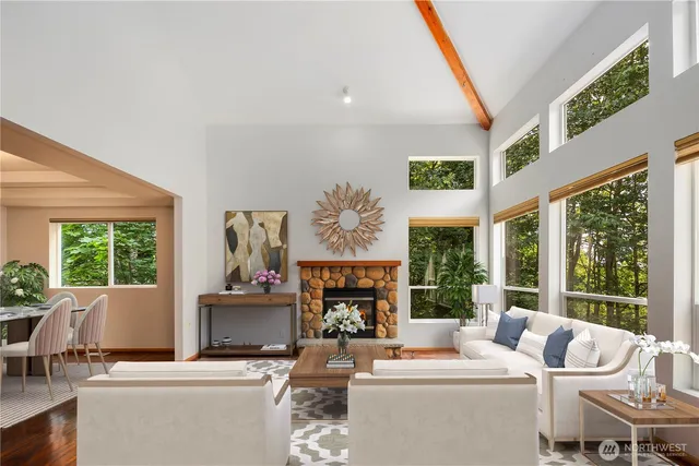 a living room with fireplace furniture and a large window