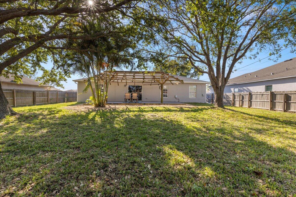 4243 Southwest Utterback Street Port St. Lucie, FL 34953 - Photo 14 of 28 a view of a house with a yard